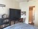 Bedroom with large TV, desk and ensuite bathroom at 763 Lakeside Dr, North Port, FL 34287