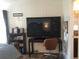 Bedroom featuring a large TV and a workspace at 763 Lakeside Dr, North Port, FL 34287