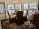 Casual dining area features a round glass table and four chairs at 763 Lakeside Dr, North Port, FL 34287