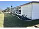 Side view of manufactured home showcasing additional landscaping at 763 Lakeside Dr, North Port, FL 34287