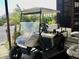 Tan EZGO golf cart with white top and accessories at 763 Lakeside Dr, North Port, FL 34287