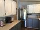 Stainless steel refrigerator and gray cabinets highlight this kitchen at 763 Lakeside Dr, North Port, FL 34287
