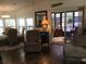 Spacious living room with comfy seating and view of screened porch at 763 Lakeside Dr, North Port, FL 34287