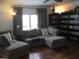 Relaxing living room with sectional sofa and extensive media collection at 763 Lakeside Dr, North Port, FL 34287