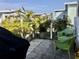 Small paved patio with potted plants and wicker chairs at 763 Lakeside Dr, North Port, FL 34287