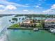 Aerial view of waterfront home on private island with boat dock and tropical landscaping at 929 Casey Cove Dr, Nokomis, FL 34275