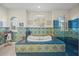 Elegant bathroom with a large soaking tub and blue patterned tile at 929 Casey Cove Dr, Nokomis, FL 34275