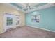 Spacious bedroom with carpet and access to balcony at 929 Casey Cove Dr, Nokomis, FL 34275