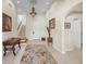 Bright and spacious entryway with elegant staircase and antique furniture at 929 Casey Cove Dr, Nokomis, FL 34275