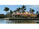 Waterfront home with a terracotta roof and lush landscaping at 929 Casey Cove Dr, Nokomis, FL 34275