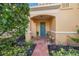 Inviting front entrance with a teal door and lush landscaping at 929 Casey Cove Dr, Nokomis, FL 34275