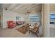 Bright living room with water views and exposed beam ceiling at 929 Casey Cove Dr, Nokomis, FL 34275