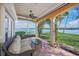 Relaxing waterfront patio with wicker furniture and stunning water views at 929 Casey Cove Dr, Nokomis, FL 34275