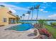 Relaxing freeform pool and patio area with water views at 929 Casey Cove Dr, Nokomis, FL 34275
