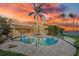 Inviting freeform pool and spa with sunset view at 929 Casey Cove Dr, Nokomis, FL 34275