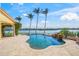Inviting freeform pool with waterfall feature and waterfront view at 929 Casey Cove Dr, Nokomis, FL 34275