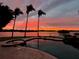 Stunning sunset view over the water from the pool at 929 Casey Cove Dr, Nokomis, FL 34275