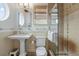 Spa-like bathroom with a pedestal sink, glass shower, and stone accents at 107 75Th St, Holmes Beach, FL 34217