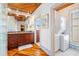 Bathroom with wood floors, laundry, and granite vanity at 107 75Th St, Holmes Beach, FL 34217