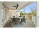Covered deck with outdoor dining set, perfect for al fresco meals at 107 75Th St, Holmes Beach, FL 34217