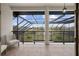 Screened balcony overlooking a tranquil landscape and pool area at 1450 Bern Creek Loop, Sarasota, FL 34240