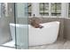 Relaxing bathroom with soaking tub, walk-in shower, and modern vanity at 1450 Bern Creek Loop, Sarasota, FL 34240