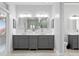 Double vanity bathroom with gray cabinets and quartz countertop at 1450 Bern Creek Loop, Sarasota, FL 34240