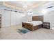 Spacious bedroom with wood flooring, large bed, and sliding barn doors at 1450 Bern Creek Loop, Sarasota, FL 34240