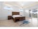Main bedroom with wood furniture and access to private balcony at 1450 Bern Creek Loop, Sarasota, FL 34240