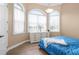Bedroom with wood floors, dresser, and blue comforter at 1450 Bern Creek Loop, Sarasota, FL 34240