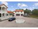 Courtyard view with fountain and two parked cars at 1450 Bern Creek Loop, Sarasota, FL 34240