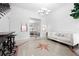 Spacious entry with a view to the living room and a star patterned floor at 1450 Bern Creek Loop, Sarasota, FL 34240