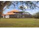 House with orange tile roof, pool, and large backyard at 1450 Bern Creek Loop, Sarasota, FL 34240