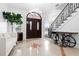 Bright foyer with tile floors and grand staircase at 1450 Bern Creek Loop, Sarasota, FL 34240