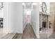Bright hallway with hardwood floors and fireplace at 1450 Bern Creek Loop, Sarasota, FL 34240