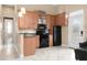 Kitchen with light wood cabinets and black appliances at 1450 Bern Creek Loop, Sarasota, FL 34240