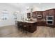 Kitchen island with seating and stainless steel appliances at 1450 Bern Creek Loop, Sarasota, FL 34240