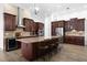 Modern kitchen with center island, dark wood cabinets, and high-end appliances at 1450 Bern Creek Loop, Sarasota, FL 34240
