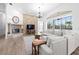 Living area with a fireplace, large sectional sofa, and wood-look floors at 1450 Bern Creek Loop, Sarasota, FL 34240