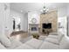 Spacious living room featuring a fireplace and large sectional sofa at 1450 Bern Creek Loop, Sarasota, FL 34240