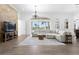 Large living room with sectional sofa, fireplace, and view to the pool at 1450 Bern Creek Loop, Sarasota, FL 34240