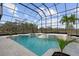 Inviting screened pool and spa with lush landscaping at 1450 Bern Creek Loop, Sarasota, FL 34240