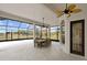 Spacious covered patio with table and chairs, overlooking a tranquil landscape at 1450 Bern Creek Loop, Sarasota, FL 34240