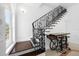 Elegant staircase with wrought iron railing and dark wood steps at 1450 Bern Creek Loop, Sarasota, FL 34240