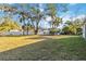 Large backyard with lush greenery at 1463 Jinright Rd, North Port, FL 34288