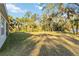 Spacious backyard with mature trees at 1463 Jinright Rd, North Port, FL 34288