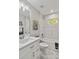 Updated bathroom with white vanity, bathtub, and marble tile at 1463 Jinright Rd, North Port, FL 34288