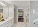 Spa-like bathroom with double vanity, marble flooring and a glass shower at 1463 Jinright Rd, North Port, FL 34288