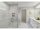 Modern bathroom with double vanity, glass shower, and marble tile at 1463 Jinright Rd, North Port, FL 34288