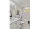 Bright bathroom features white cabinets, marble tile, and a bathtub at 1463 Jinright Rd, North Port, FL 34288